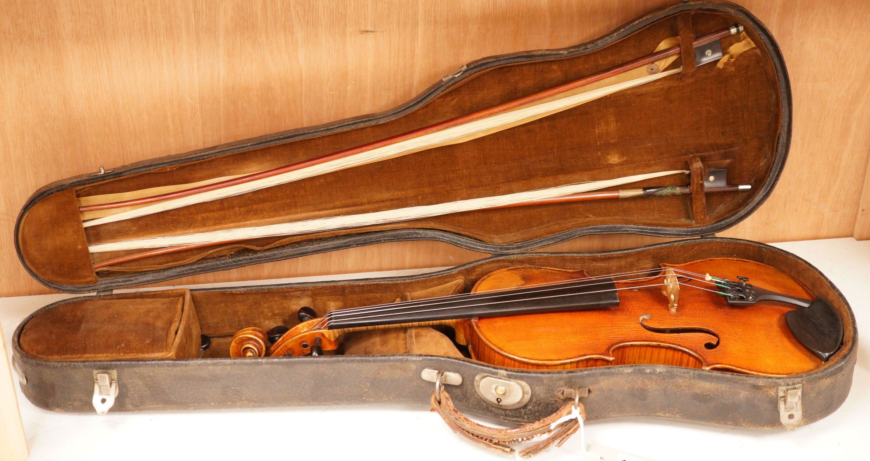 A 19th century violin labelled JB Guadagnini, back measures 35cm, with two bows, one silver-mounted.